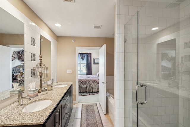 bathroom with vanity, tile patterned flooring, and walk in shower