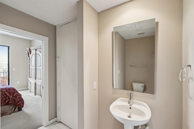 bathroom featuring toilet and sink