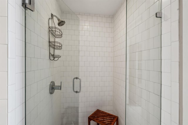 bathroom with a shower with door