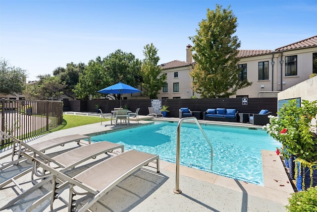 view of swimming pool featuring outdoor lounge area and a patio