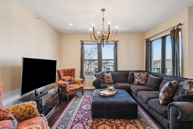 living room with wood-type flooring and an inviting chandelier