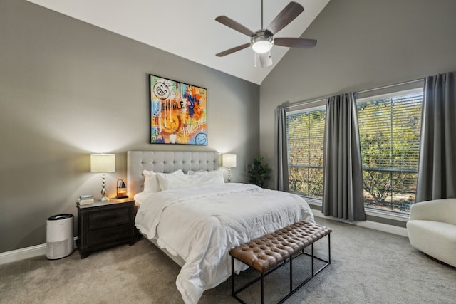 carpeted bedroom with ceiling fan and high vaulted ceiling