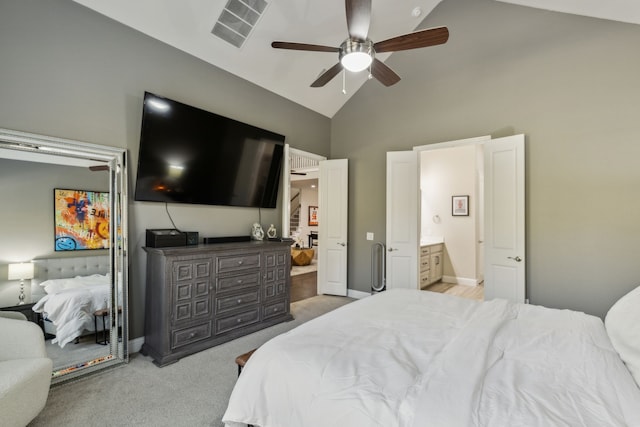 bedroom featuring ceiling fan, light colored carpet, ensuite bath, and high vaulted ceiling