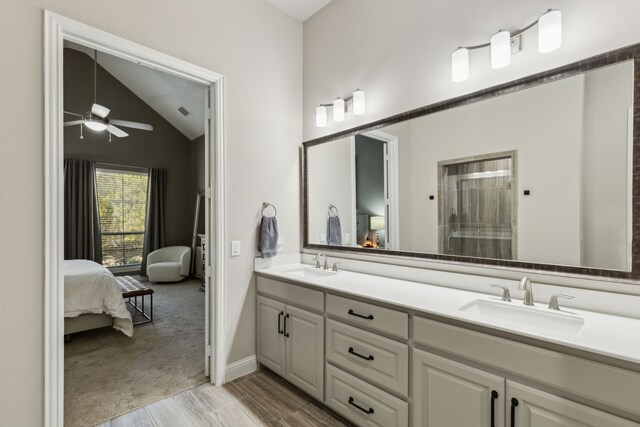 bathroom featuring ceiling fan, vanity, and lofted ceiling