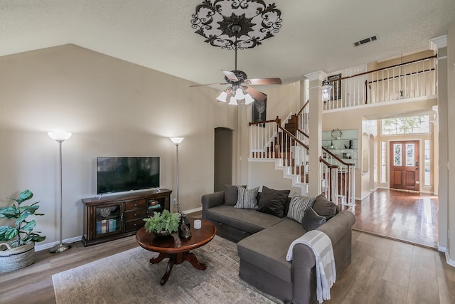 living room featuring ceiling fan, hardwood / wood-style flooring, and high vaulted ceiling