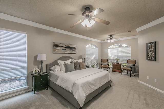 carpeted bedroom featuring ceiling fan, crown molding, and a textured ceiling