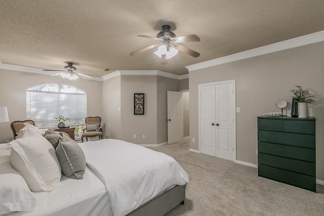 bedroom with a textured ceiling, ceiling fan, crown molding, and light colored carpet