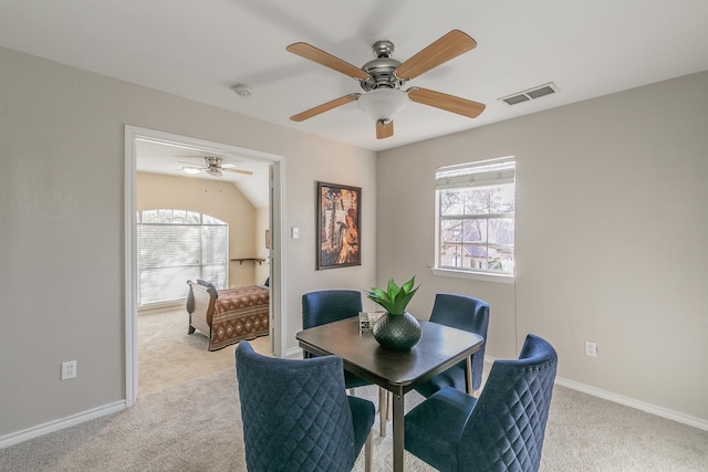 carpeted dining room featuring ceiling fan