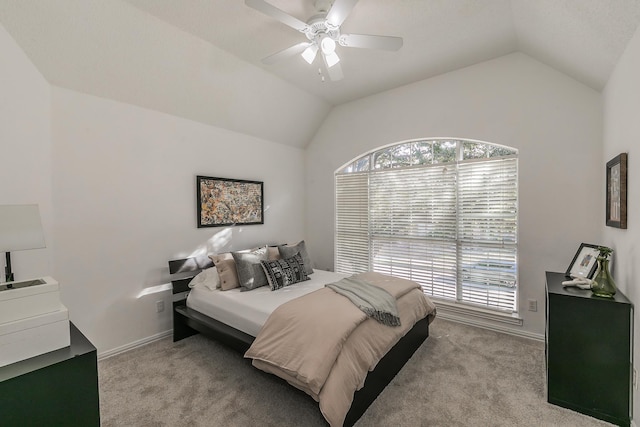 bedroom featuring ceiling fan, light colored carpet, and vaulted ceiling