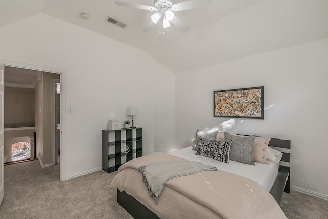 bedroom with ceiling fan, ornamental molding, light carpet, and vaulted ceiling