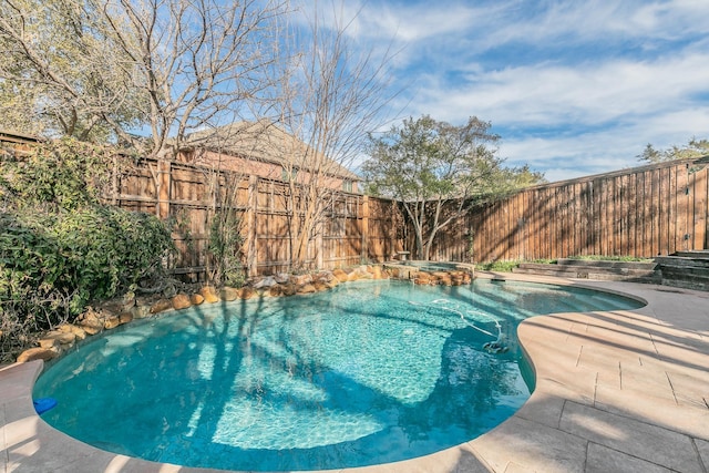 view of swimming pool with an in ground hot tub and a patio