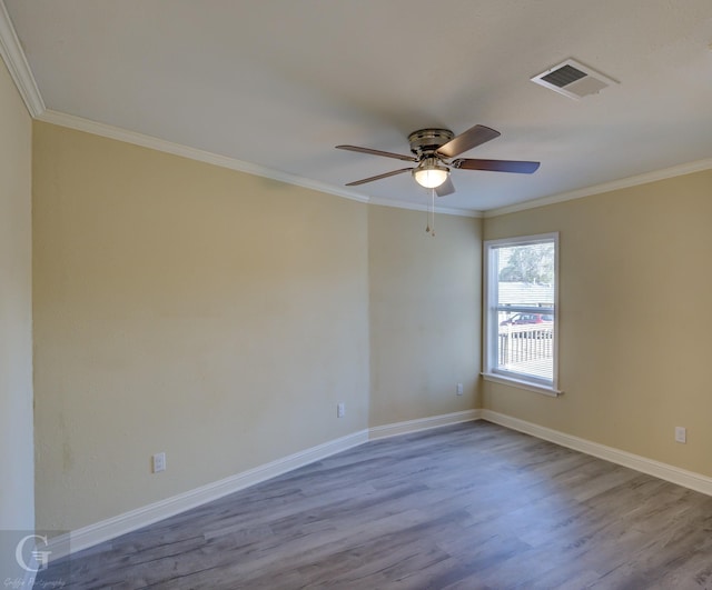 unfurnished room featuring ceiling fan, light wood-type flooring, and ornamental molding