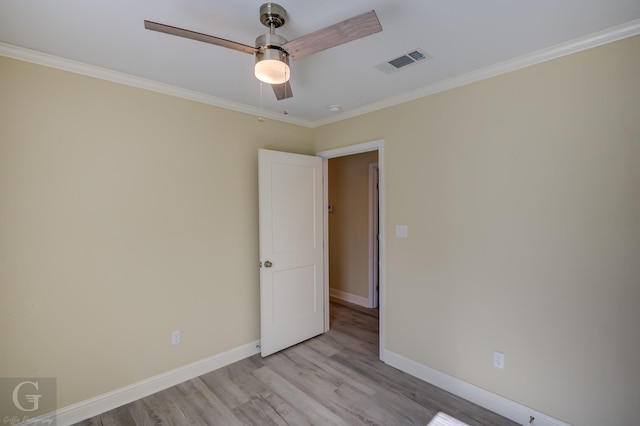 unfurnished room with ceiling fan, crown molding, and light hardwood / wood-style floors