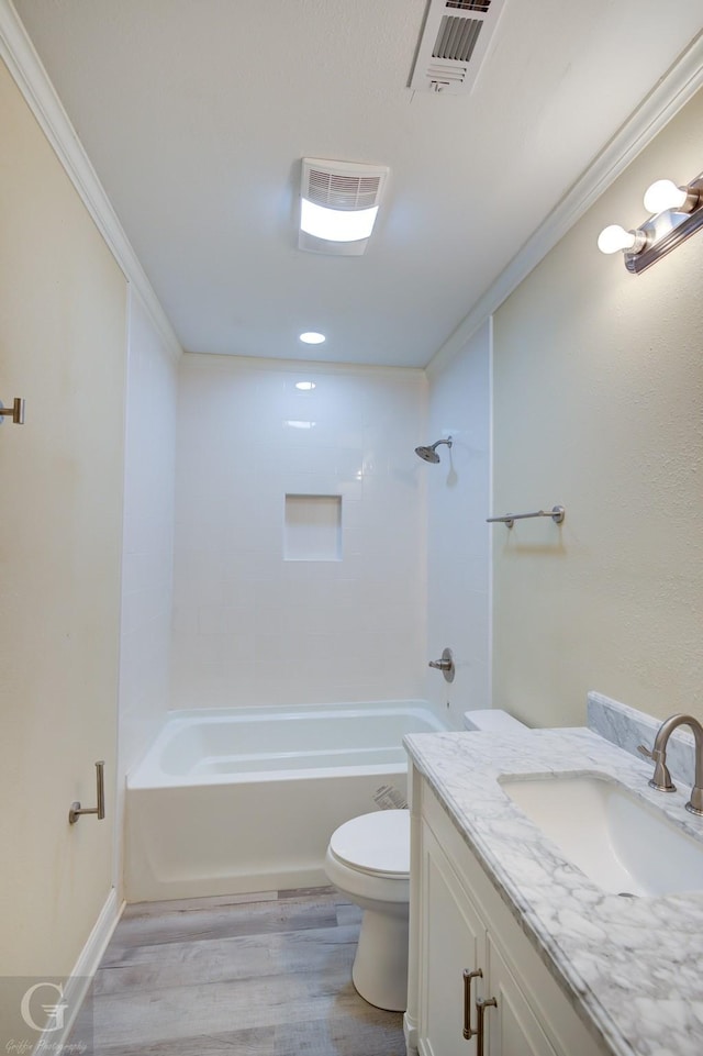 full bathroom with hardwood / wood-style floors, toilet, vanity, and crown molding