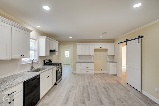 kitchen featuring a barn door, sink, black dishwasher, white cabinetry, and stainless steel gas range