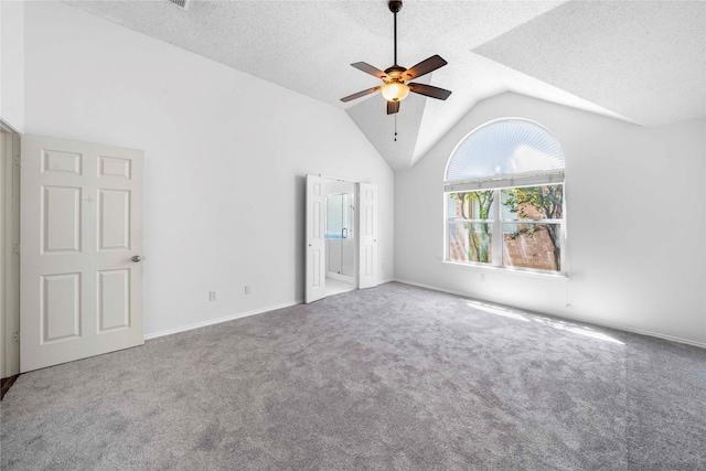 unfurnished bedroom featuring lofted ceiling, ceiling fan, a textured ceiling, and carpet flooring