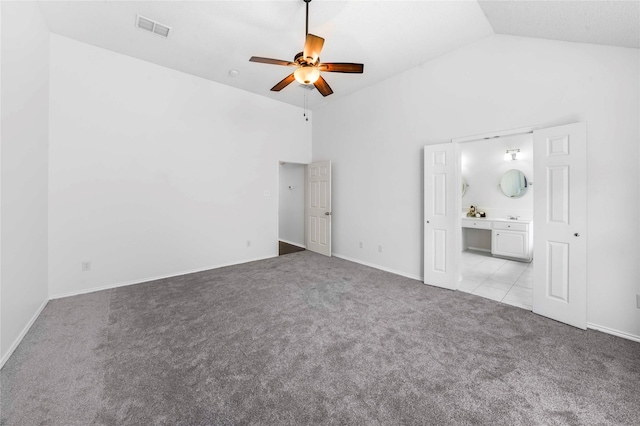 unfurnished living room featuring ceiling fan, light colored carpet, and high vaulted ceiling