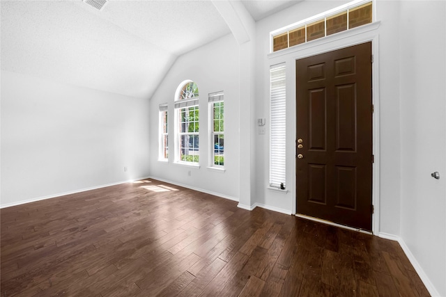 entryway featuring a textured ceiling, dark hardwood / wood-style flooring, and vaulted ceiling with beams