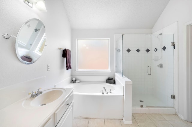 bathroom featuring lofted ceiling, vanity, tile patterned floors, a textured ceiling, and shower with separate bathtub