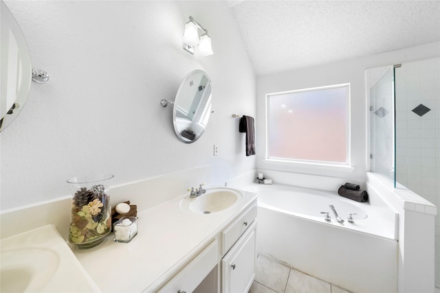 bathroom with a textured ceiling, tile patterned flooring, shower with separate bathtub, and vanity