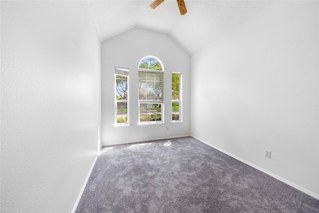 unfurnished room featuring vaulted ceiling, ceiling fan, a textured ceiling, and carpet floors