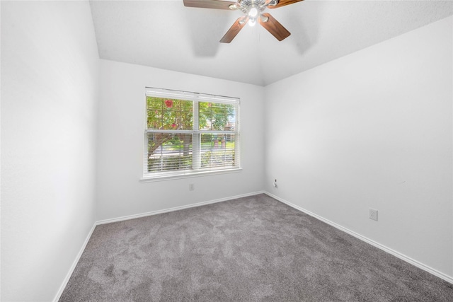 empty room with ceiling fan, lofted ceiling, and carpet floors