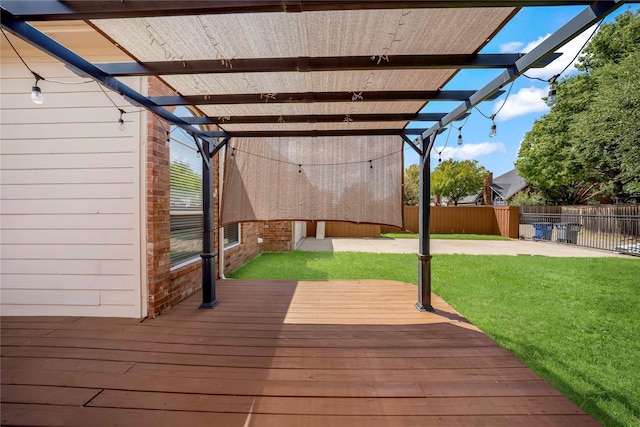 wooden deck with a lawn, a pergola, and a patio area