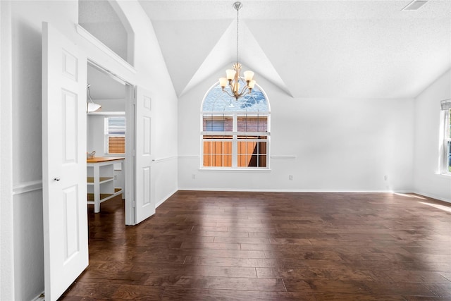 unfurnished dining area featuring vaulted ceiling, dark hardwood / wood-style flooring, and an inviting chandelier