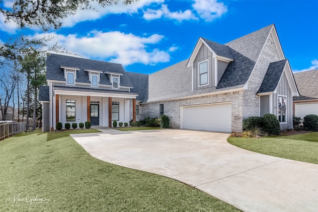 view of front of house with a front yard, a porch, and a garage