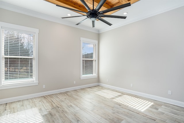 spare room featuring light wood-type flooring, ceiling fan, and crown molding