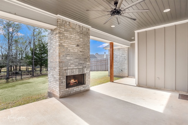 view of patio featuring an outdoor brick fireplace and ceiling fan