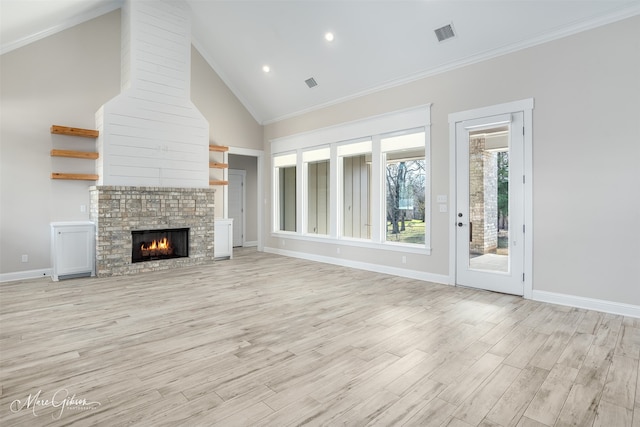 unfurnished living room featuring high vaulted ceiling, light wood-type flooring, crown molding, and a fireplace