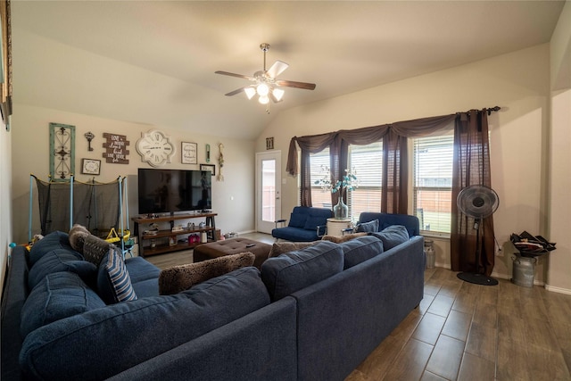 living room with dark wood-style floors, baseboards, a ceiling fan, and vaulted ceiling