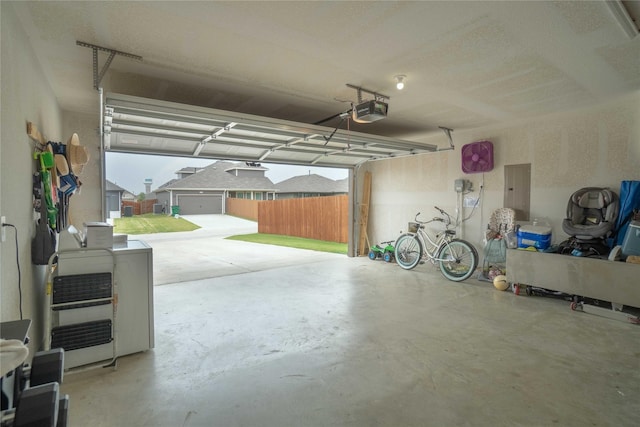 garage featuring electric panel and a garage door opener