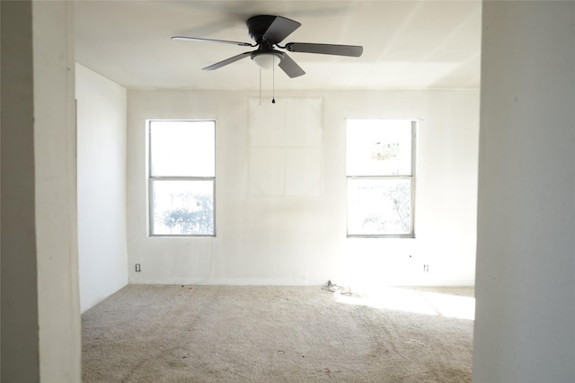 carpeted spare room with ceiling fan