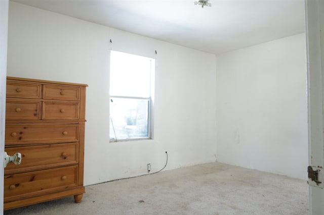 spare room with light colored carpet