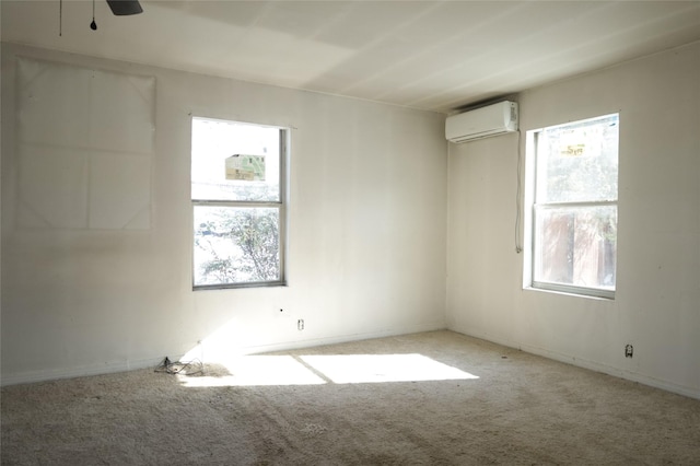 empty room featuring light carpet, a wall mounted AC, and ceiling fan