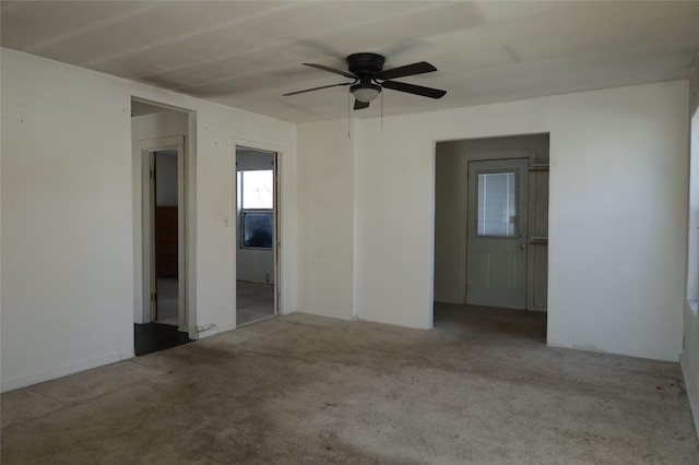 spare room with ceiling fan and light carpet