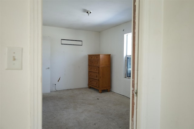 unfurnished room with light carpet