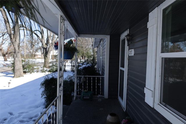 view of snow covered back of property