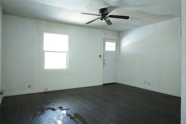 spare room featuring ceiling fan and dark hardwood / wood-style floors