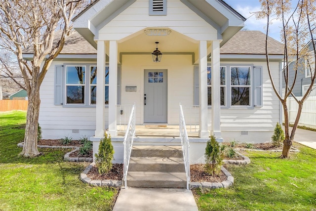 view of exterior entry featuring a lawn