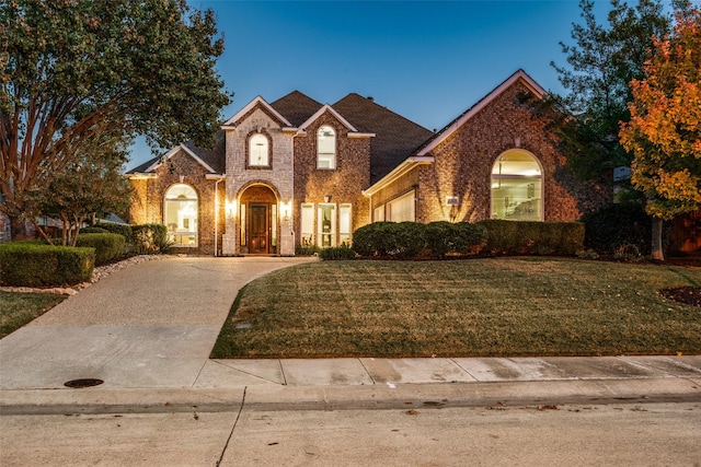 view of property featuring a lawn and a garage