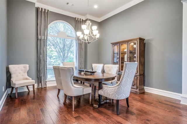 dining area featuring an inviting chandelier, ornamental molding, and dark hardwood / wood-style floors