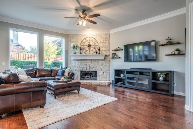 living room with ceiling fan, ornamental molding, and a fireplace