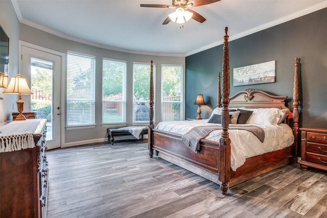 bedroom featuring ceiling fan, hardwood / wood-style floors, ornamental molding, and access to outside