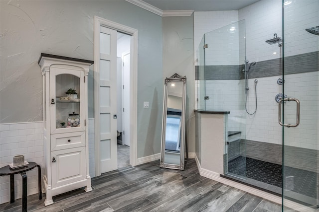 bathroom featuring hardwood / wood-style floors, walk in shower, and crown molding