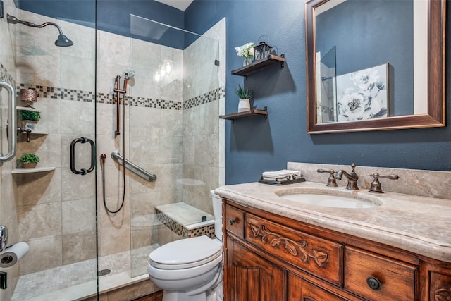 bathroom featuring toilet, walk in shower, and vanity