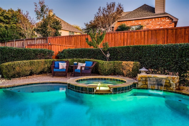 view of pool with pool water feature and an in ground hot tub