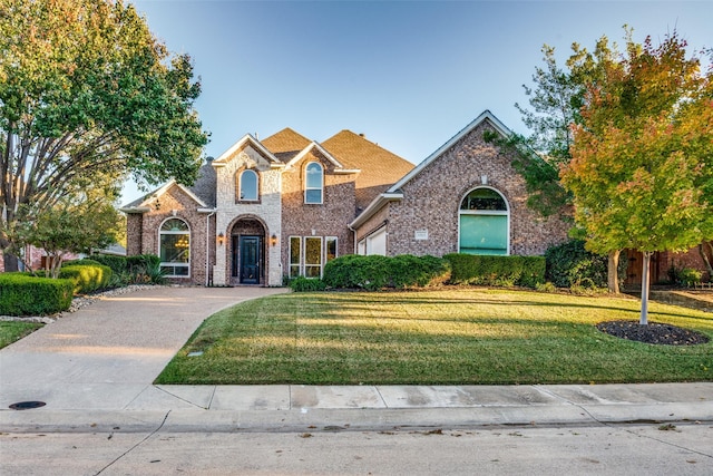 view of front property with a front lawn and a garage